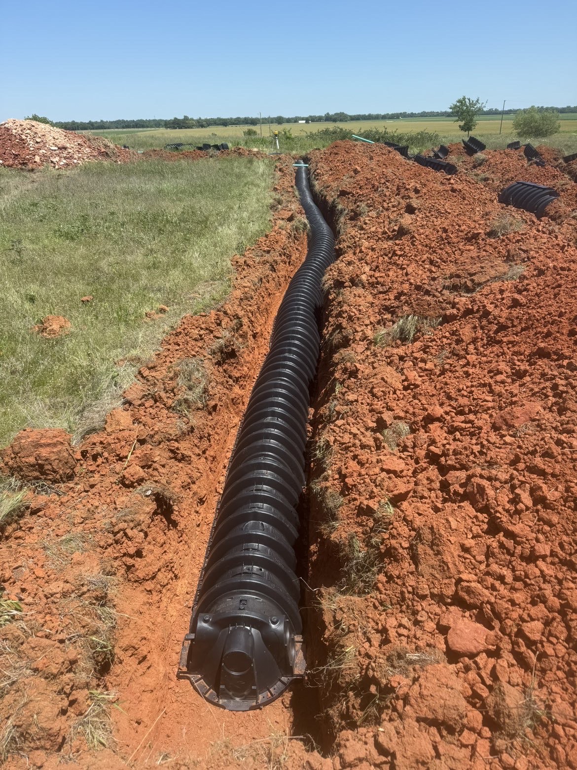 Septic line and infiltrator chambers set in a trench